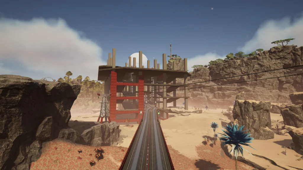 Screenshot from the game Satisfactory. Down the centre of the photo is a rail line that leads into a large structure that is under construction.
