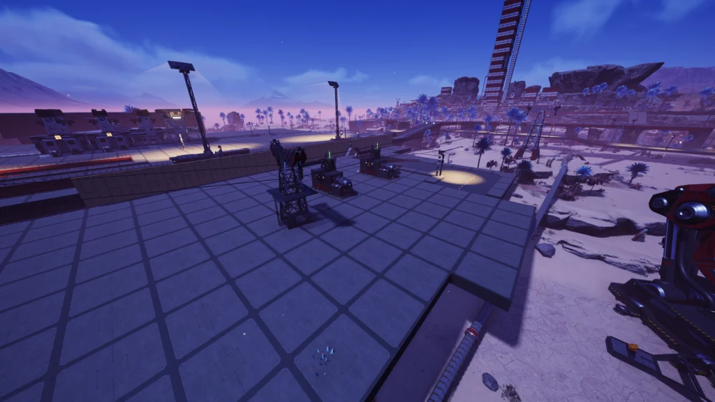 Screenshot from the game Satisfactory. Showing a large area covered with concrete foundations and truck stops in the middle. There is also a power tower clipping through the foundations.